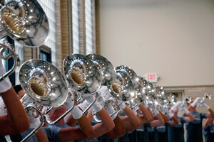 The brass section performs the 2010 production.